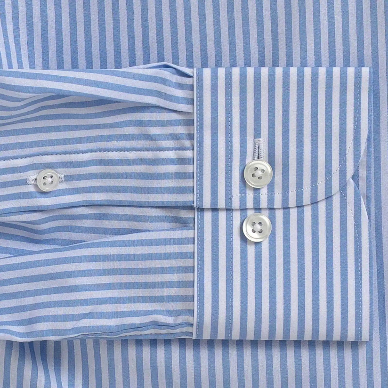 Close-up of a light blue and white striped dress shirt showing the buttoned cuff and front placket.