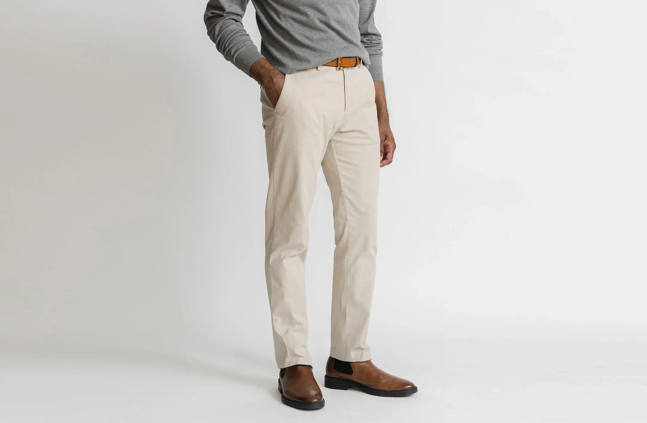 Model wearing Men's Ledbury Richmond Chino custom pants in tan. 