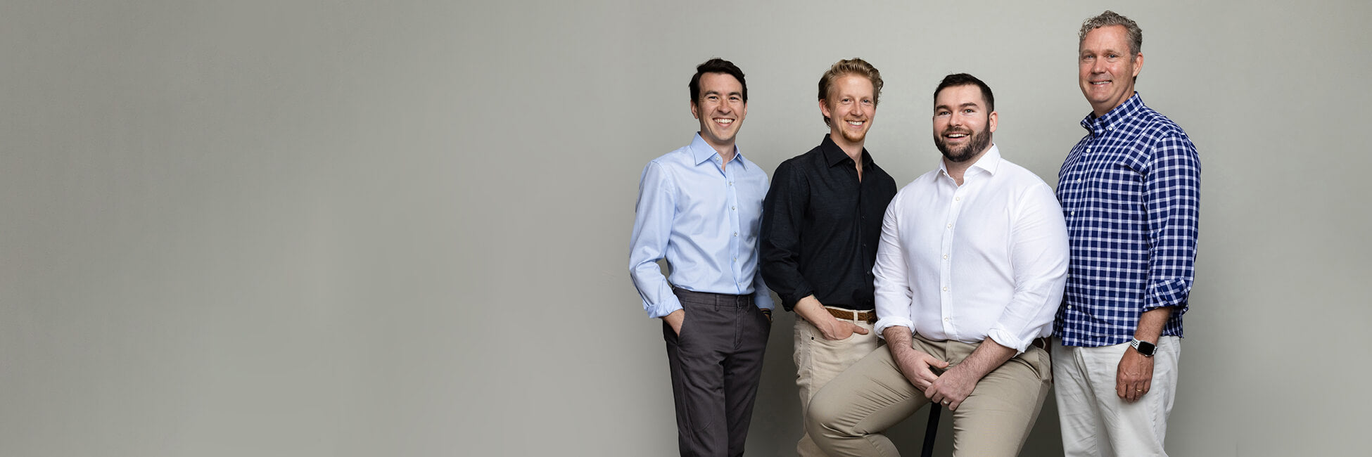 Group of men standing together wearing different sizes and fits of Ledbury shirts