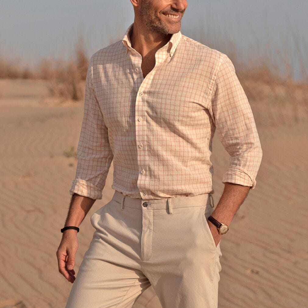 Model wearing a breathable cotton linen button down shirt in pale pink and cream 