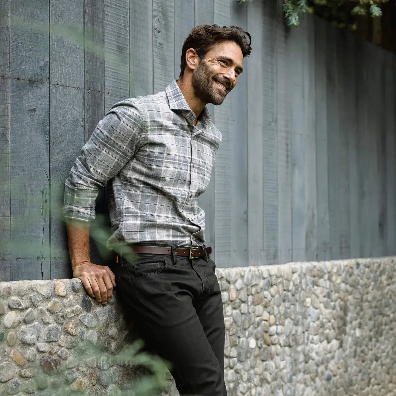 Man wearing Light Grey Callisto Plaid flannel shirt in an outdoor setting - casual lifestyle photo