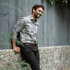 Man wearing Light Grey Callisto Plaid flannel shirt in an outdoor setting - casual lifestyle photo