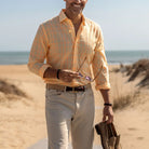 Man wearing the Yellow Torello Check custom shirt standing on the beach 