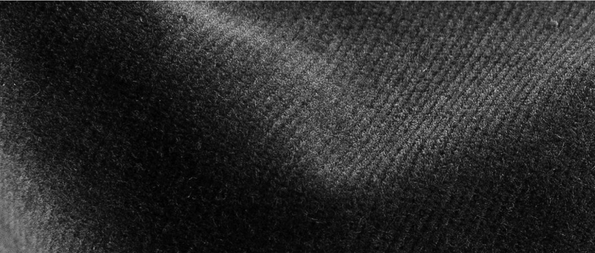 Closeup of dark slate grey corduroy textured fabric 